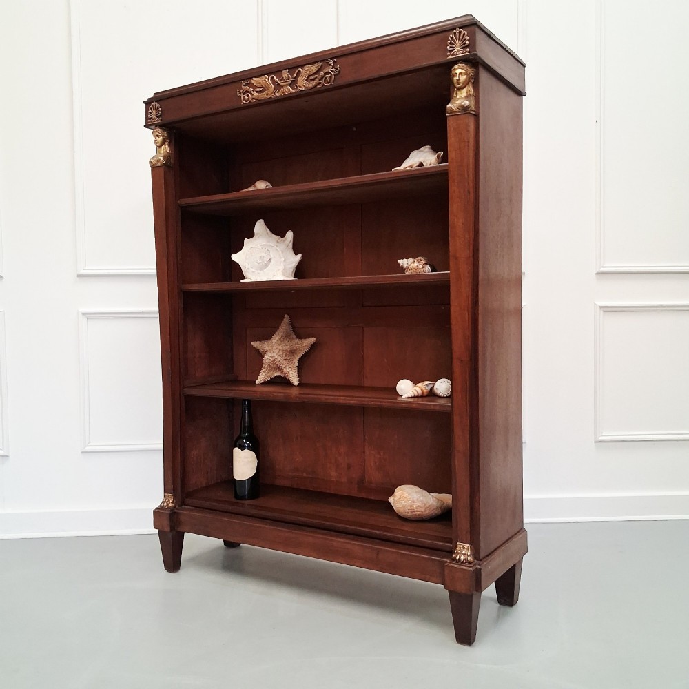 Large French mahogany open bookcase featuring four horizontal shelves flanked by side columns topped with gilded caryatid mounts. View III
