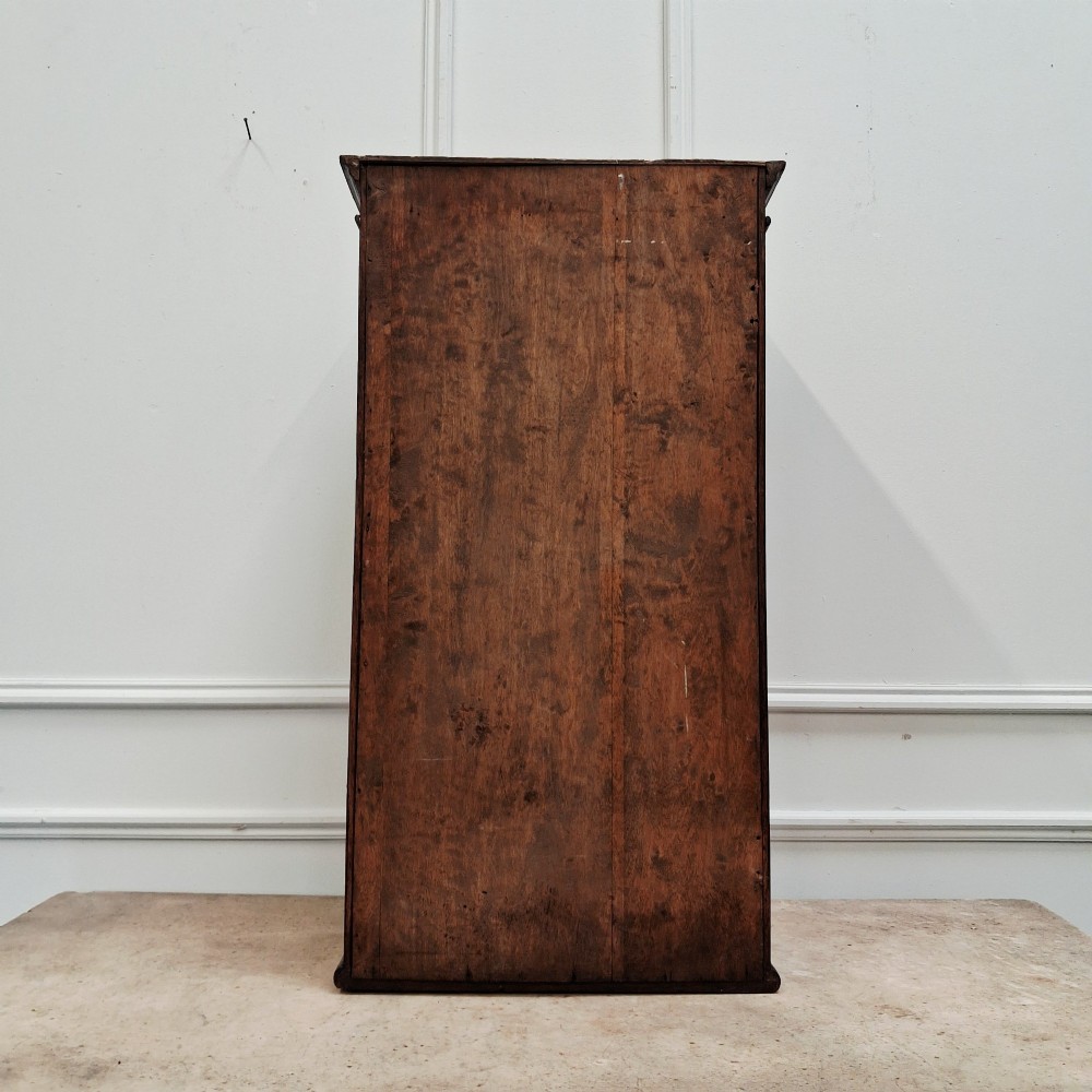 An antique medium brown oak wall cupboard featuring a panelled single door with Clean Towels in gilt lettering across the top and a brass door knob. View VII