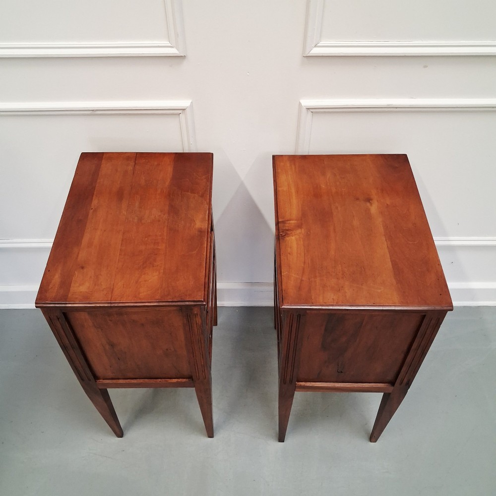 A pair of French antique walnut bedside tables with three drawers and slender tapered legs. View III
