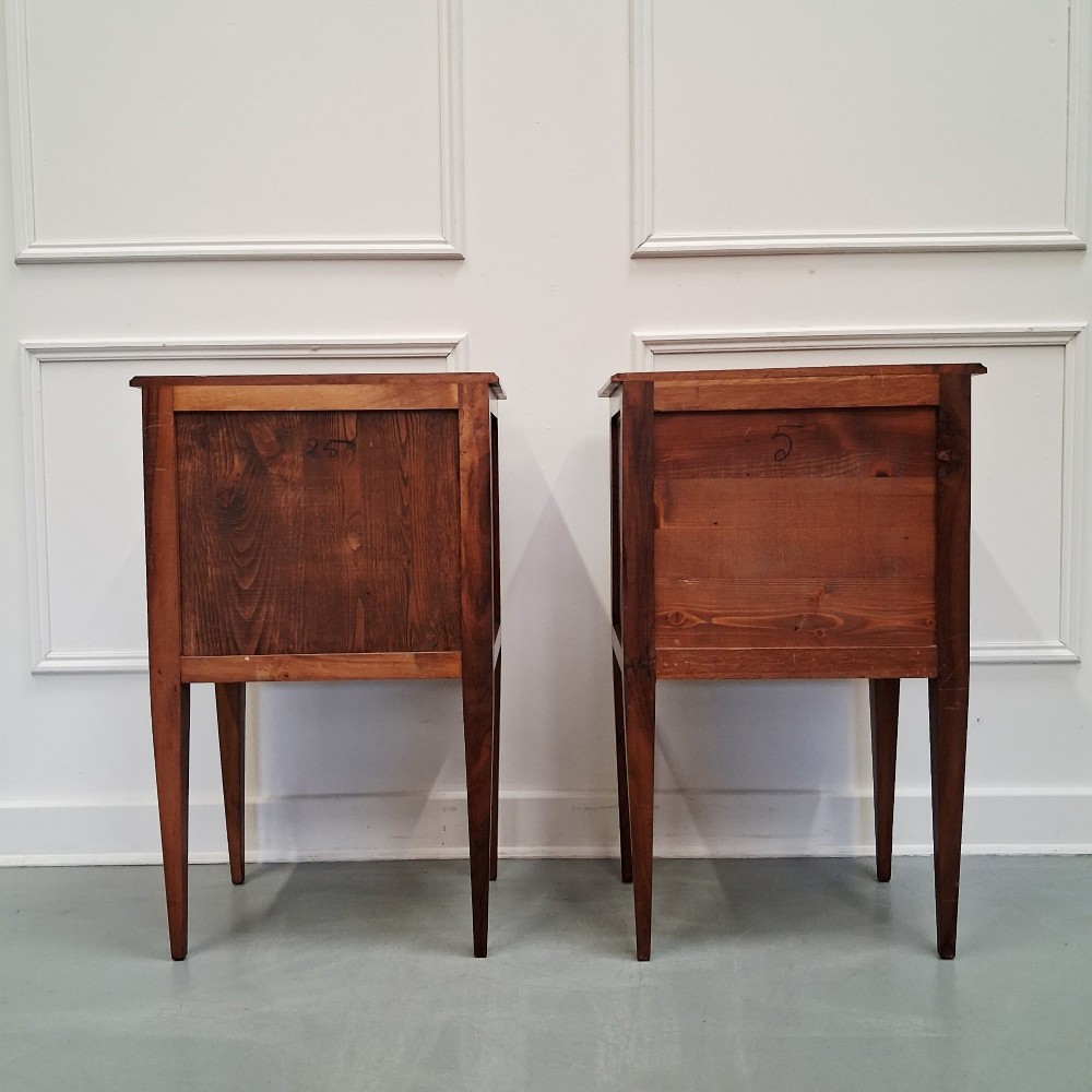 A pair of French antique walnut bedside tables with three drawers and slender tapered legs. View IV