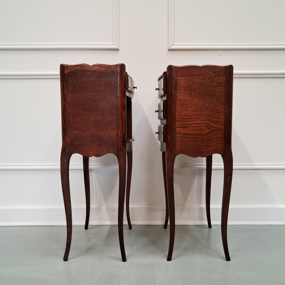 A pair of 1930s French oak bedside tables with slender cabriole legs, one featuring three drawers and the other featuring a single drawer above an open compartment. View III