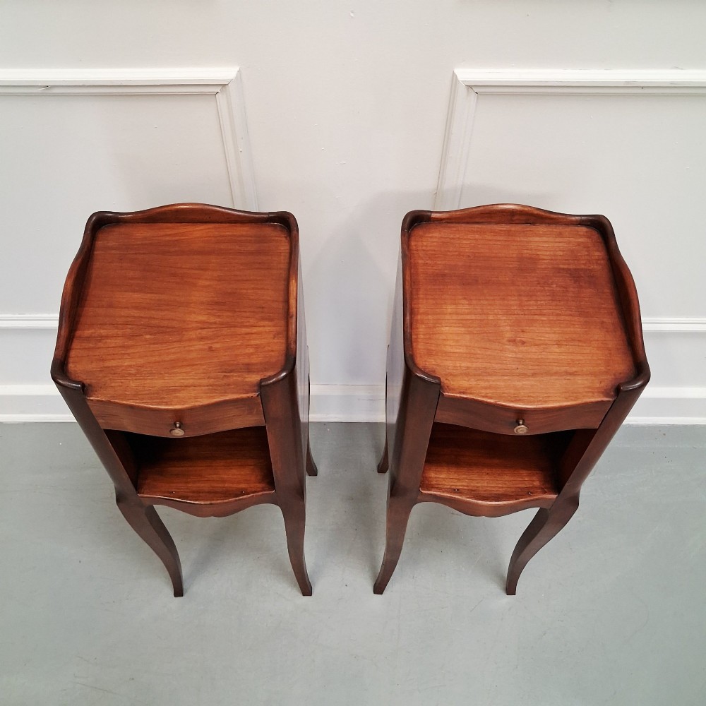 A pair of tall French cherry wood bedside tables with single drawers, open storage niches, and slender cabriole legs. View II