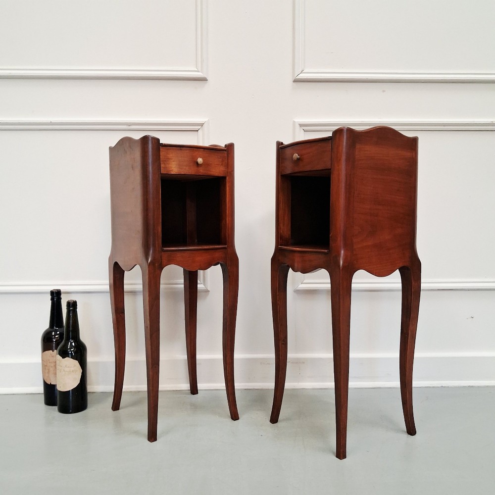 A pair of tall French cherry wood bedside tables with single drawers, open storage niches, and slender cabriole legs. View IV
