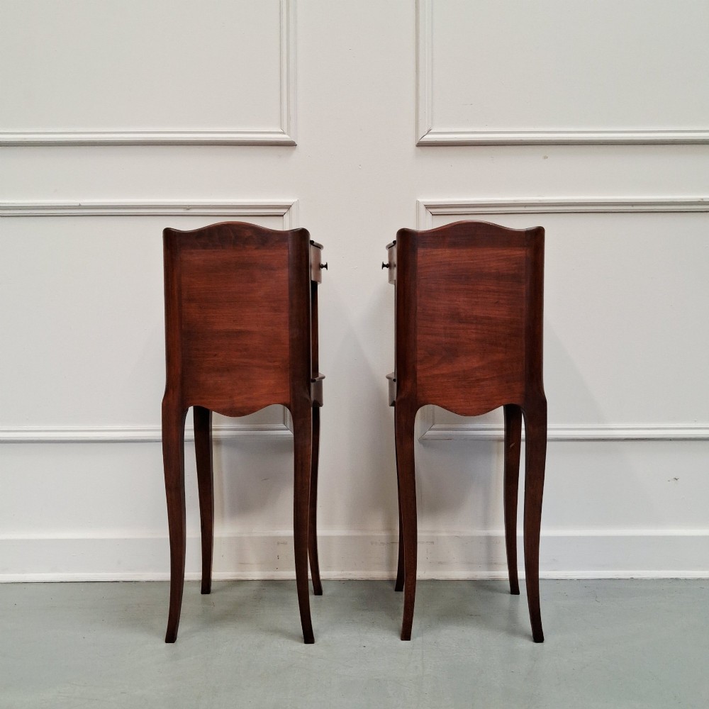 A pair of tall French cherry wood bedside tables with single drawers, open storage niches, and slender cabriole legs. View V