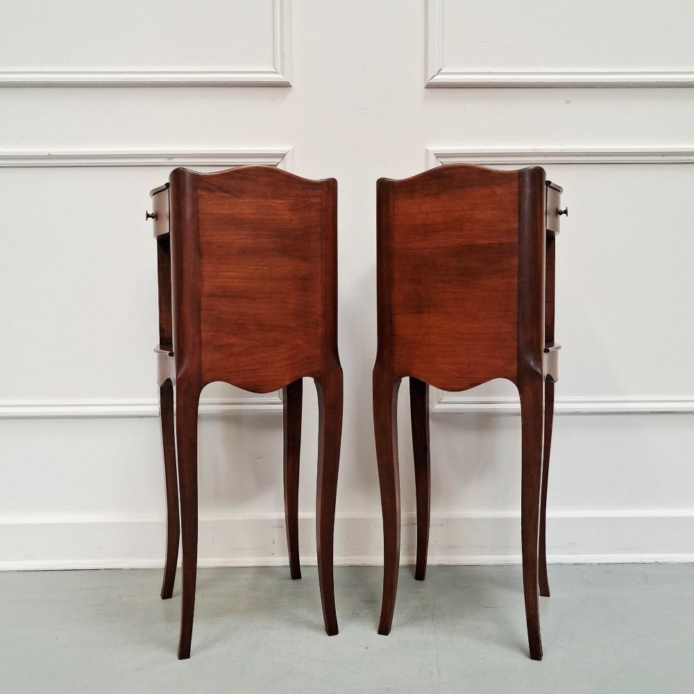 A pair of tall French cherry wood bedside tables with single drawers, open storage niches, and slender cabriole legs. View VII