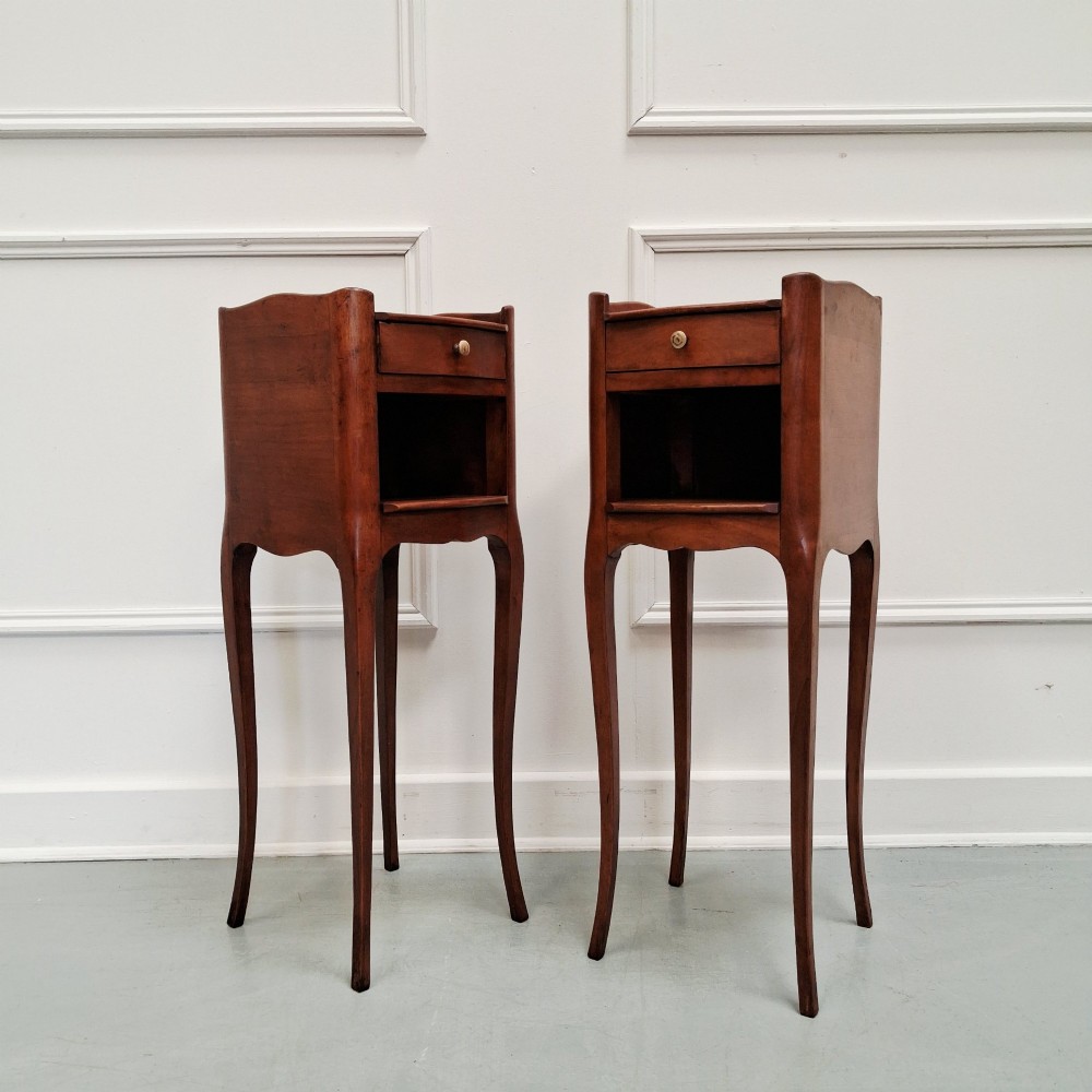 A pair of tall French cherry wood bedside tables featuring single frieze drawers, open compartments, and slender cabriole legs. View II