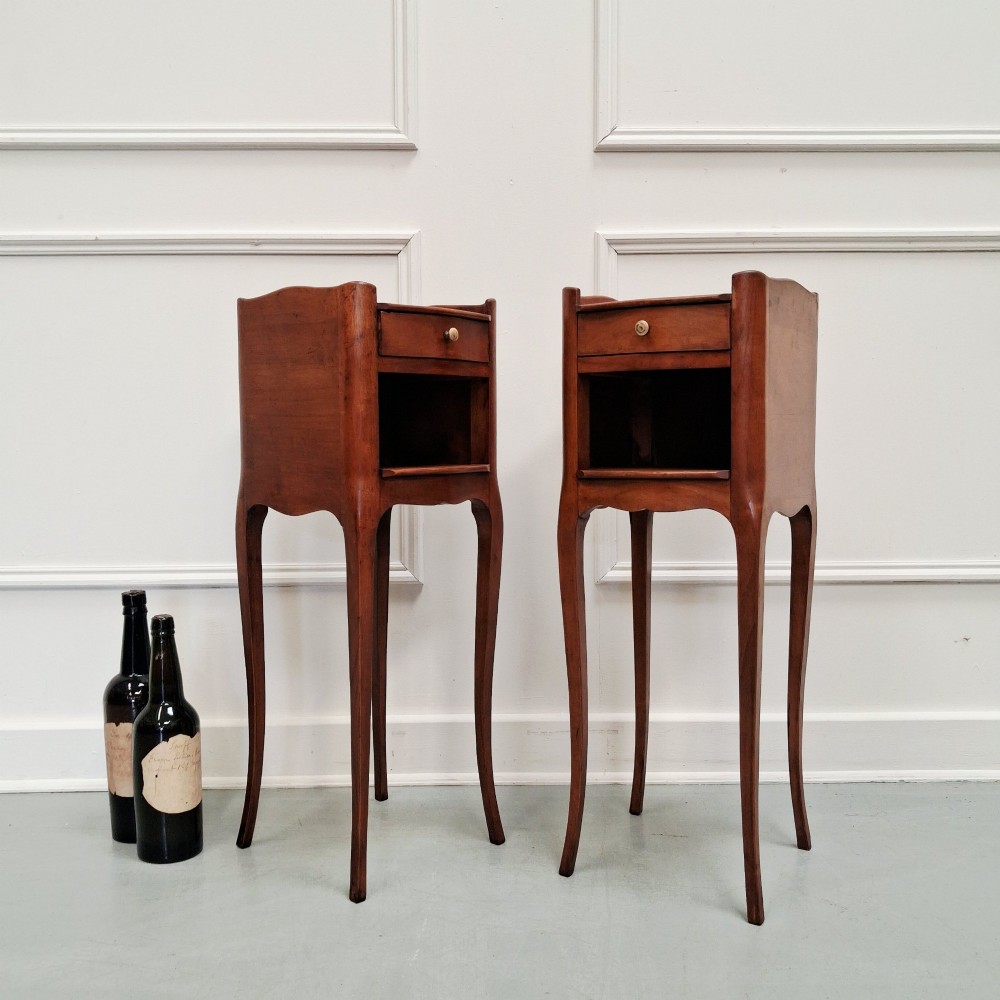 A pair of tall French cherry wood bedside tables featuring single frieze drawers, open compartments, and slender cabriole legs. View III