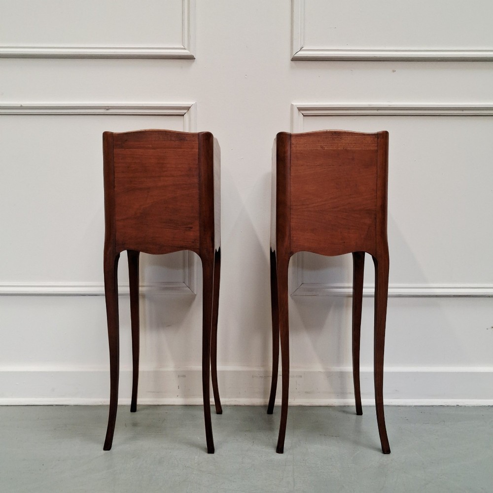 A pair of tall French cherry wood bedside tables featuring single frieze drawers, open compartments, and slender cabriole legs. View V