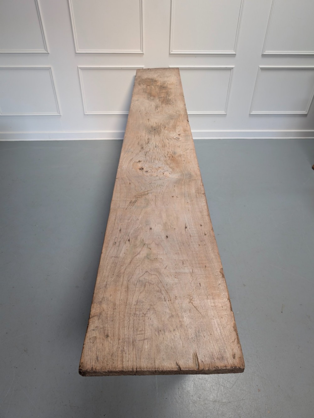 An exceptionally long, narrow 19th-century French wooden laundry table featuring A-frame legs and diagonal structural supports. View III