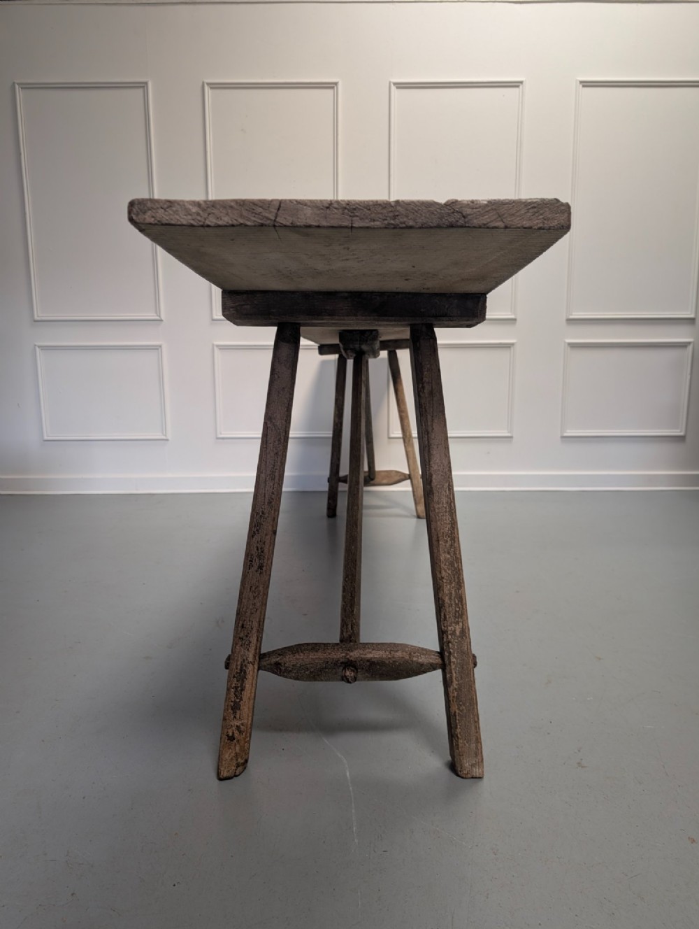 An exceptionally long, narrow 19th-century French wooden laundry table featuring A-frame legs and diagonal structural supports. View VI