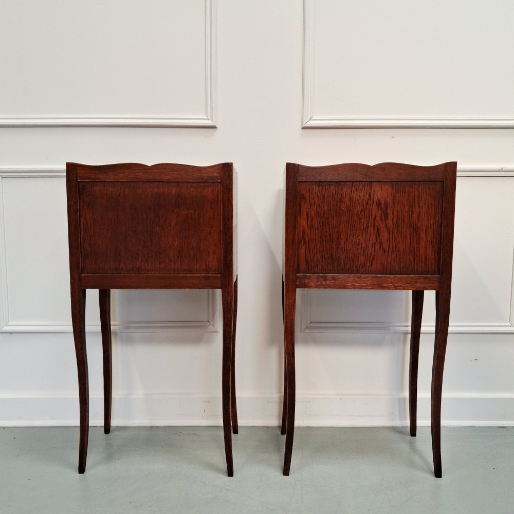 A pair of tall French oak bedside tables featuring single top drawers, open storage alcoves, scalloped aprons, and slender curved cabriole legs. View III