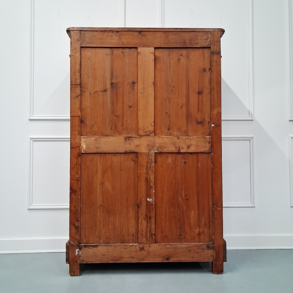 A tall 19th-century French wooden semainier chest featuring seven drawers framed by turned faux bamboo mouldings and supported by bun feet. View VI