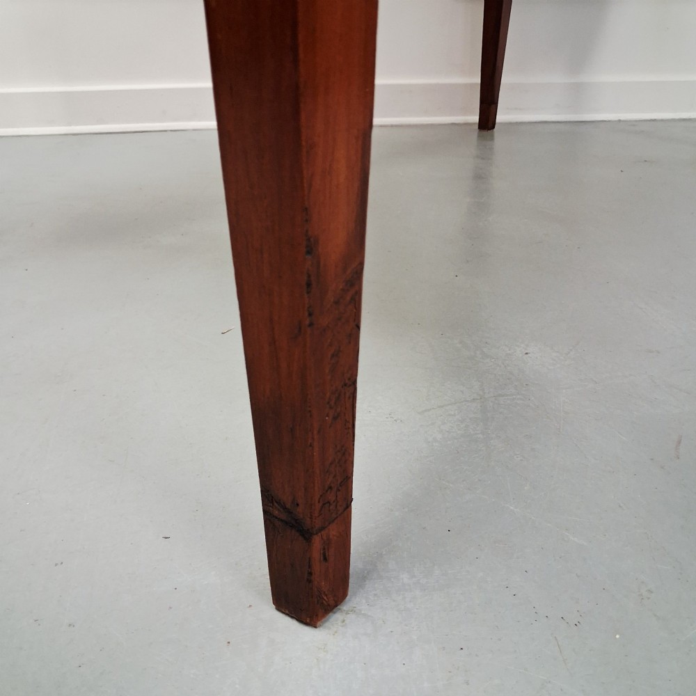 A late 19th-century French farmhouse dining table constructed from warm cherry wood featuring square tapered legs and an integrated frieze drawer. View IX