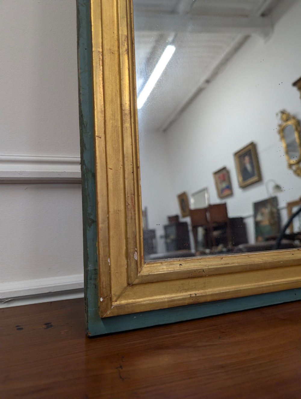 A rectangular 1920s French wall mirror with a gilded inner frame profile surrounded by a slate grey painted border. View II