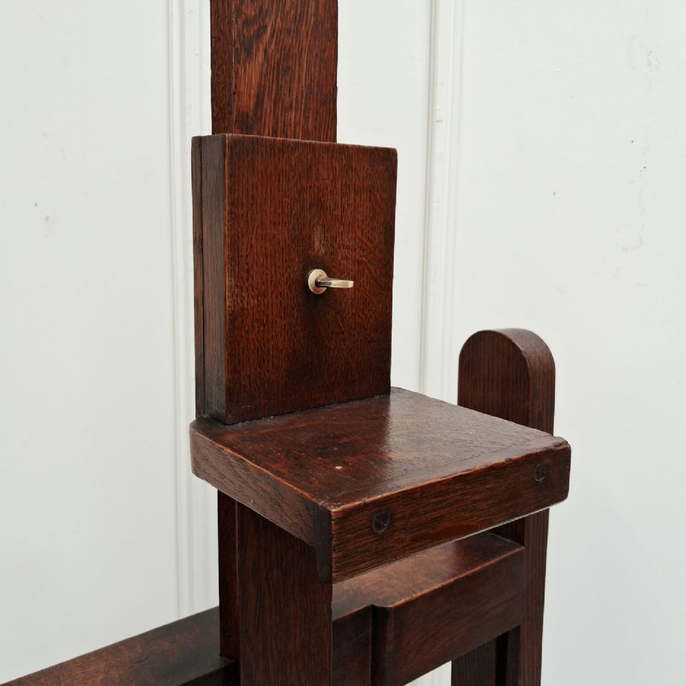 A dark oak French studio easel from circa 1890 featuring an adjustable vertical shaft, horizontal support shelf, and caster feet. View IV