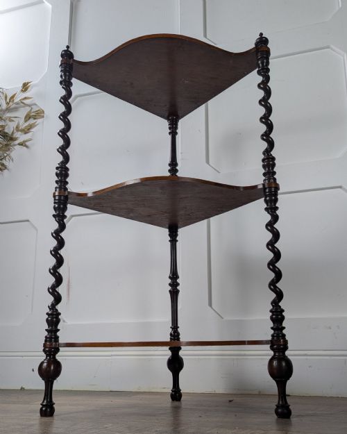 fig 1. A Victorian dark mahogany three-tier corner whatnot featuring spiralled barley twist front supports and finial details.