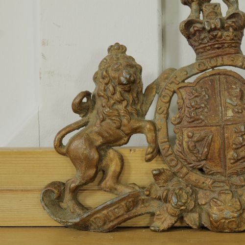 fig 1. A Victorian cast metal relief plaque depicting the Royal Coat of Arms of the United Kingdom flanked by a lion and unicorn.