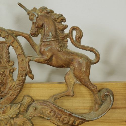 fig 2. A Victorian cast metal relief plaque depicting the Royal Coat of Arms of the United Kingdom flanked by a lion and unicorn.