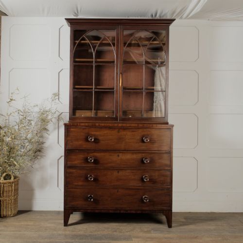 fig 2. A 19th-century mahogany secretaire bookcase featuring an upper glazed cabinet with gothic arch doors and a lower chest of drawers.