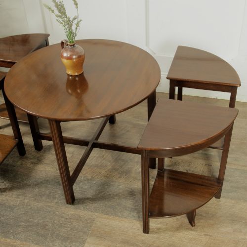 fig 1. An Edwardian mahogany nest of five circular tables featuring four individual quarter-circle side tables stacked beneath the central round table.