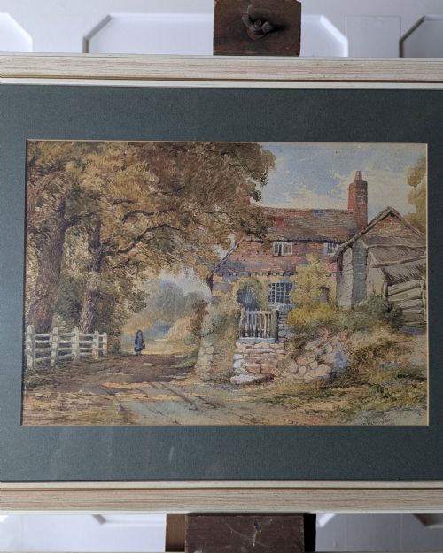 fig 1. Pair of 1879 Victorian watercolour paintings depicting rural English cottage landscapes, presented in dark green mounts and light wood frames.
