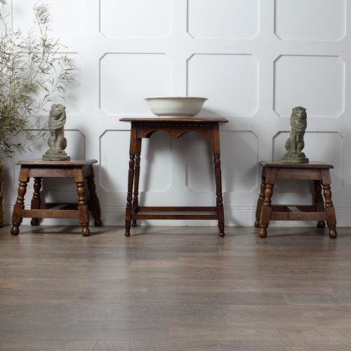 fig 1. A late Victorian solid oak side table featuring carved apron arches, turned legs, and a rectangular top supported by low box stretchers.