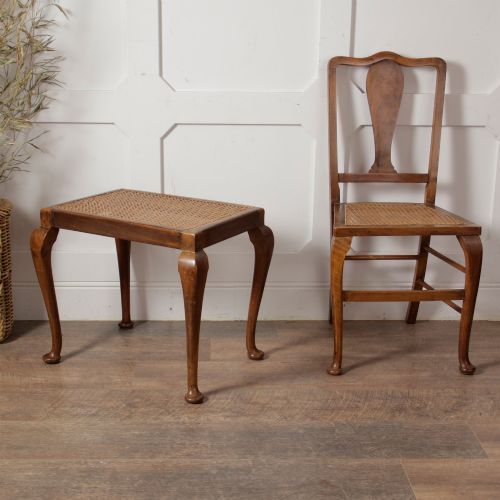 fig 1. A low walnut luggage stand featuring a rectangular woven rattan top supported by four cabriole legs with pad feet.