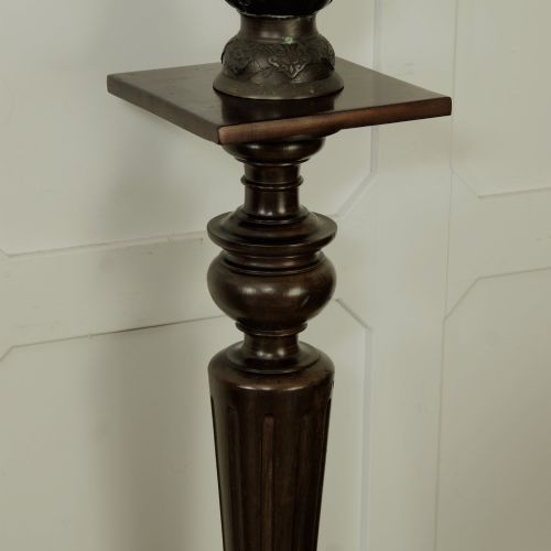 fig 2. A dark turned mahogany plinth stand featuring a square top and base with a fluted central column.