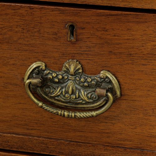 fig 2. A late Victorian mahogany chest of drawers featuring two short drawers over two long drawers with brass handles on a plinth base.