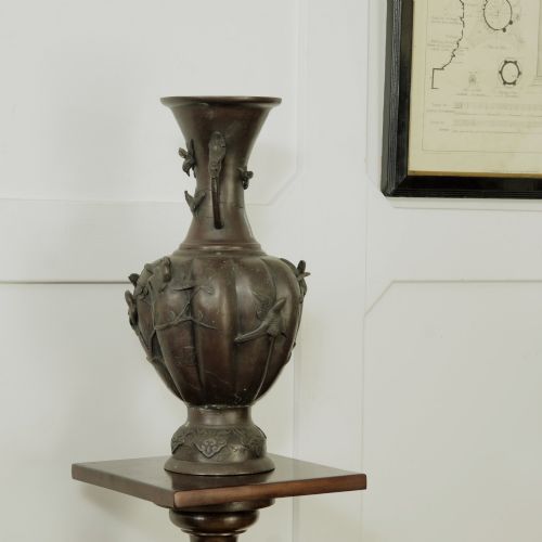 fig 1. A dark brown patinated bronze vase featuring relief-carved bird motifs, flared neck, and twin dragon handles.