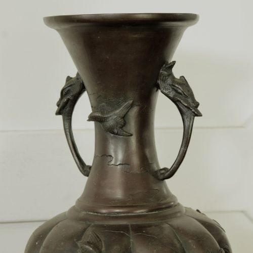 fig 2. A dark brown patinated bronze vase featuring relief-carved bird motifs, flared neck, and twin dragon handles.