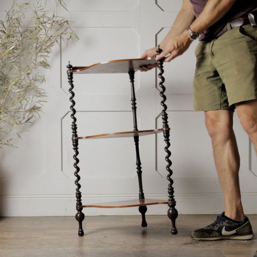 fig 1. A Victorian mahogany corner whatnot featuring three shaped tiers supported by carved barley twist columns and turned finials.