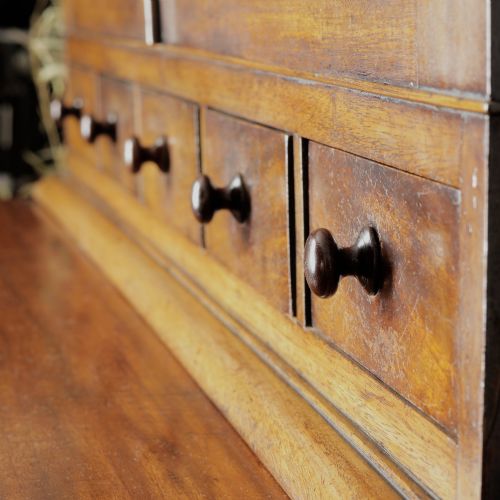 fig 1. A two-tier Victorian mahogany chiffonier bookcase with arched glass double doors on the upper section and panelled cupboard doors on the lower base.