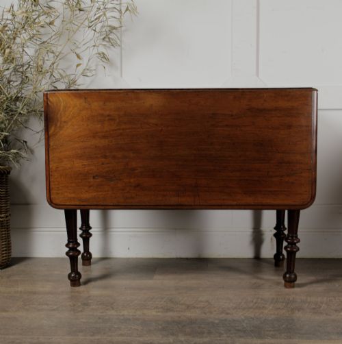 fig 1. A Victorian mahogany gateleg table with two hinged drop leaves, a rectangular top, and turned wooden legs.