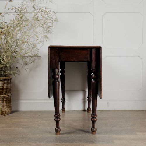 fig 2. A Victorian mahogany gateleg table with two hinged drop leaves, a rectangular top, and turned wooden legs.