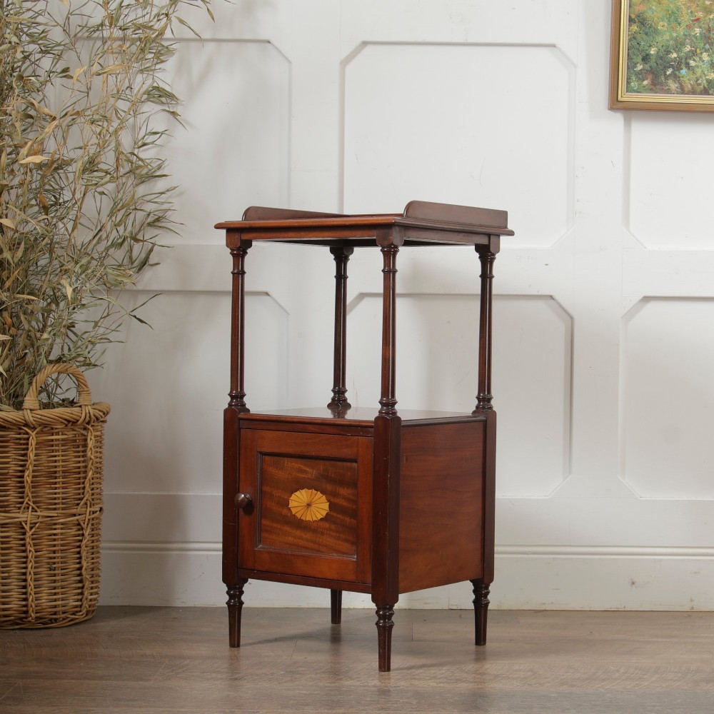 A Victorian mahogany pot cupboard with an open upper shelf supported by turned columns, sitting above a single-door cupboard adorned with a central marquetry inlay. View III