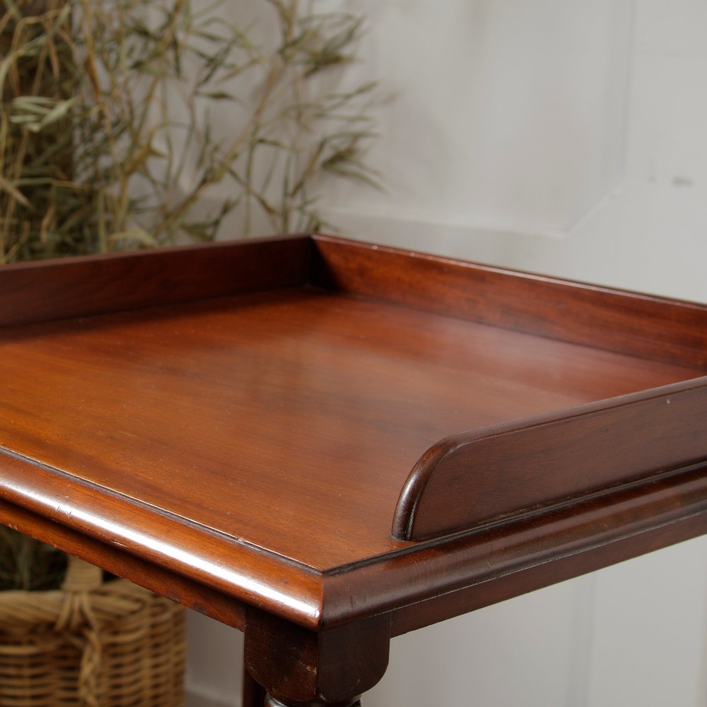 A Victorian mahogany pot cupboard with an open upper shelf supported by turned columns, sitting above a single-door cupboard adorned with a central marquetry inlay. View X