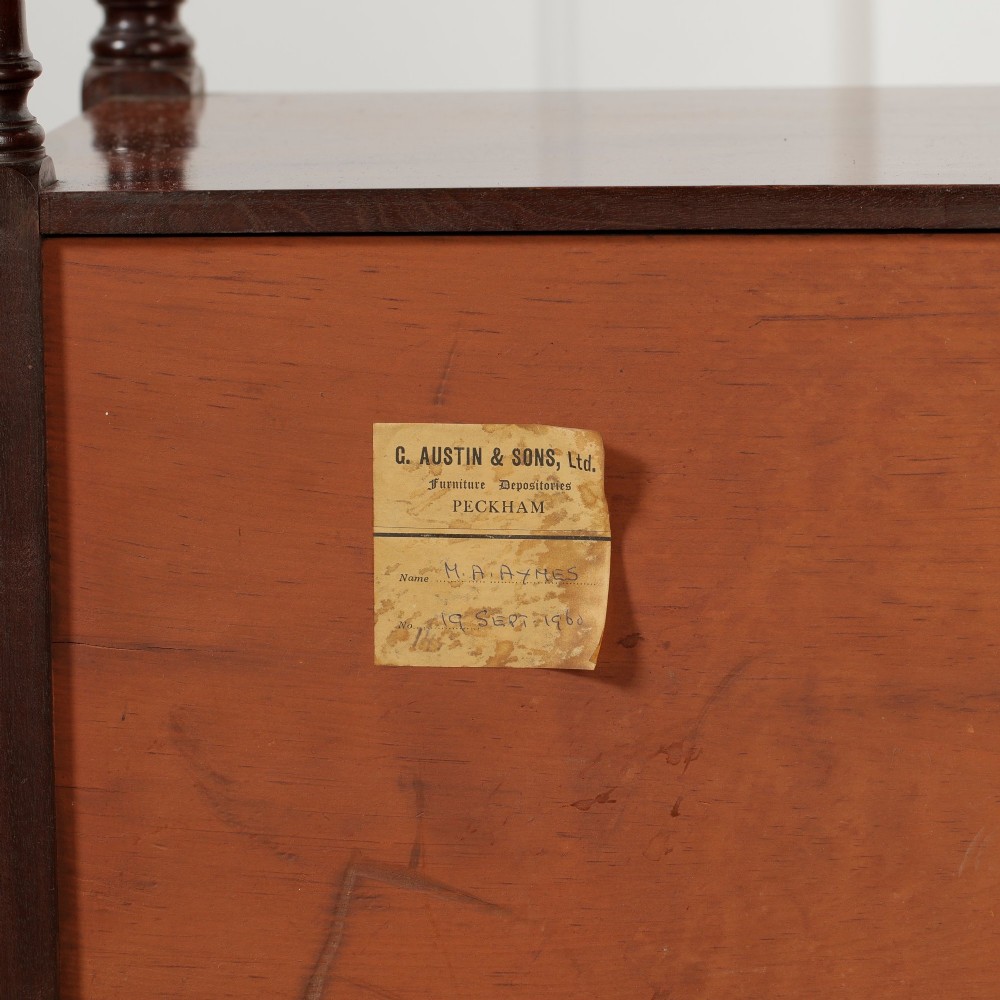 A Victorian mahogany pot cupboard with an open upper shelf supported by turned columns, sitting above a single-door cupboard adorned with a central marquetry inlay. View XIV
