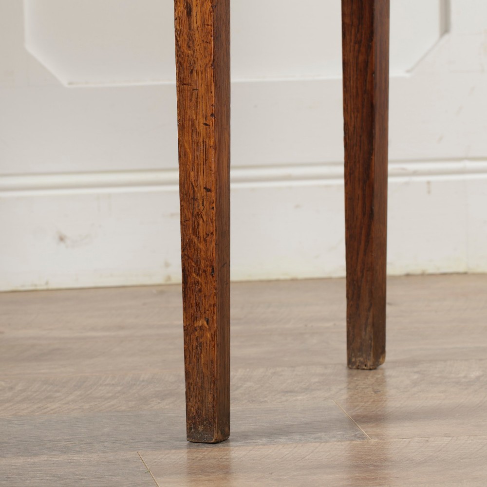 A George III Georgian oak side table featuring a single drawer with a brass handle plate and four square tapered legs. View V