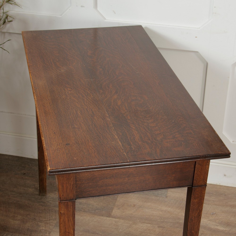 A George III Georgian oak side table featuring a single drawer with a brass handle plate and four square tapered legs. View XV