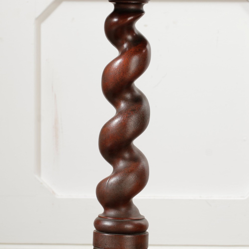 A Victorian dark walnut pedestal table featuring a circular top, a central barley twist turned column, and a tripod base. View V