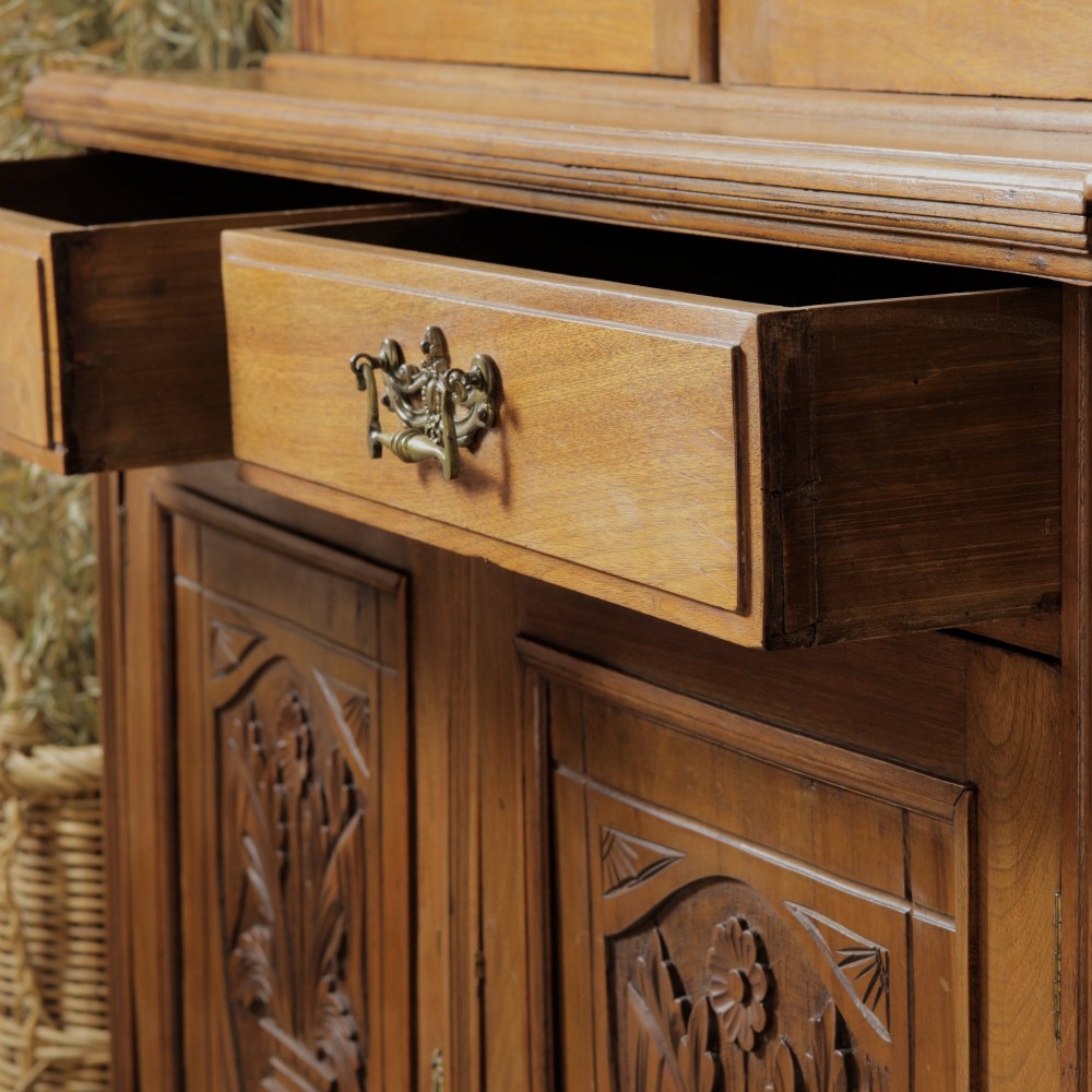 A late Victorian wooden glazed bookcase featuring two upper glass doors above two drawers and a double-door cupboard carved with floral urn motifs. View IX