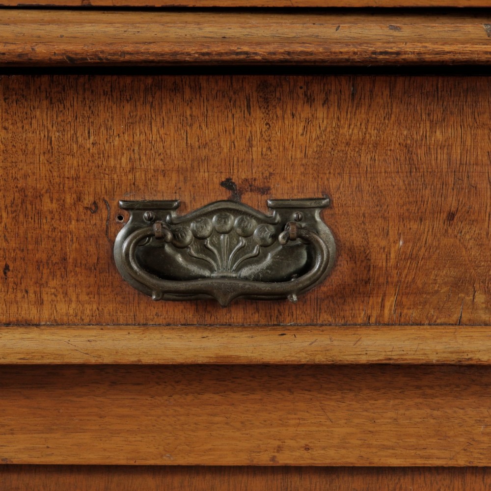 A mid-Victorian mahogany bookcase featuring a two-door glazed upper section, a single frieze drawer, and a lower cupboard with carved panel doors. View VI