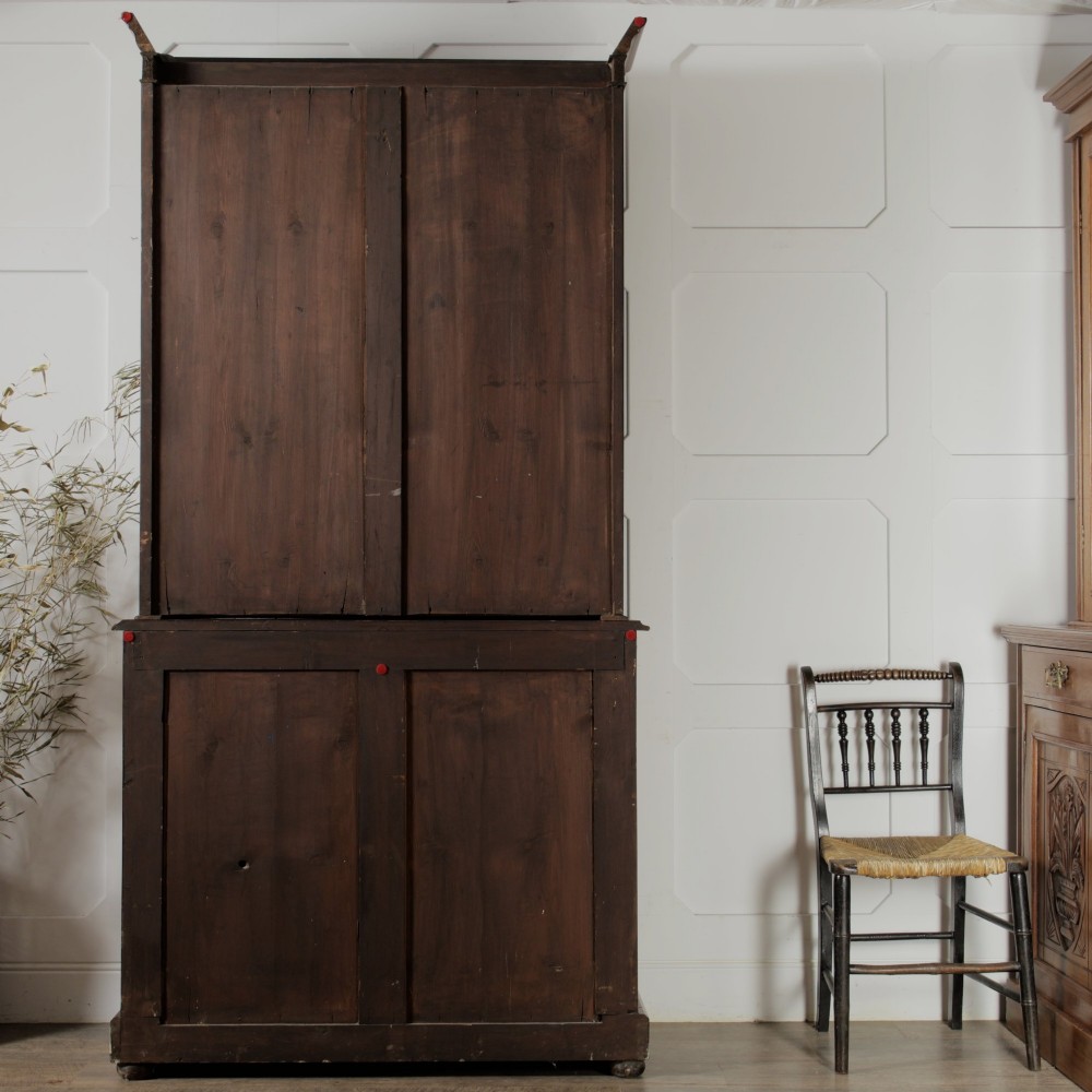 A mid-Victorian mahogany bookcase featuring a two-door glazed upper section, a single frieze drawer, and a lower cupboard with carved panel doors. View XV