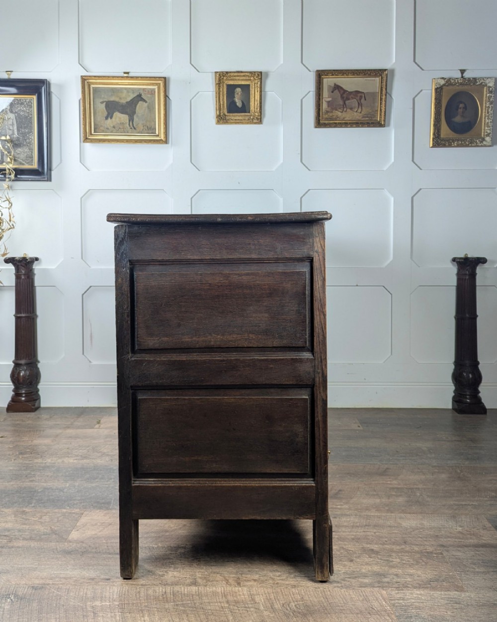 An 18th-century dark oak mule chest featuring four fielded front panels above three small drawers with brass handles. View VI