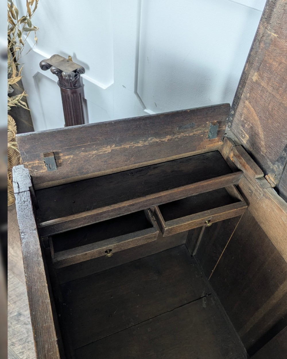 An 18th-century dark oak mule chest featuring four fielded front panels above three small drawers with brass handles. View XIII