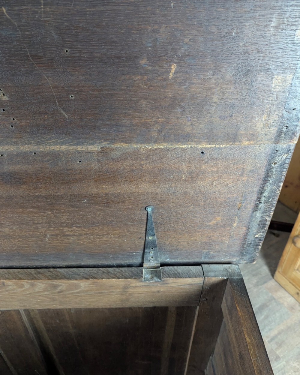 An 18th-century dark oak mule chest featuring four fielded front panels above three small drawers with brass handles. View XIV
