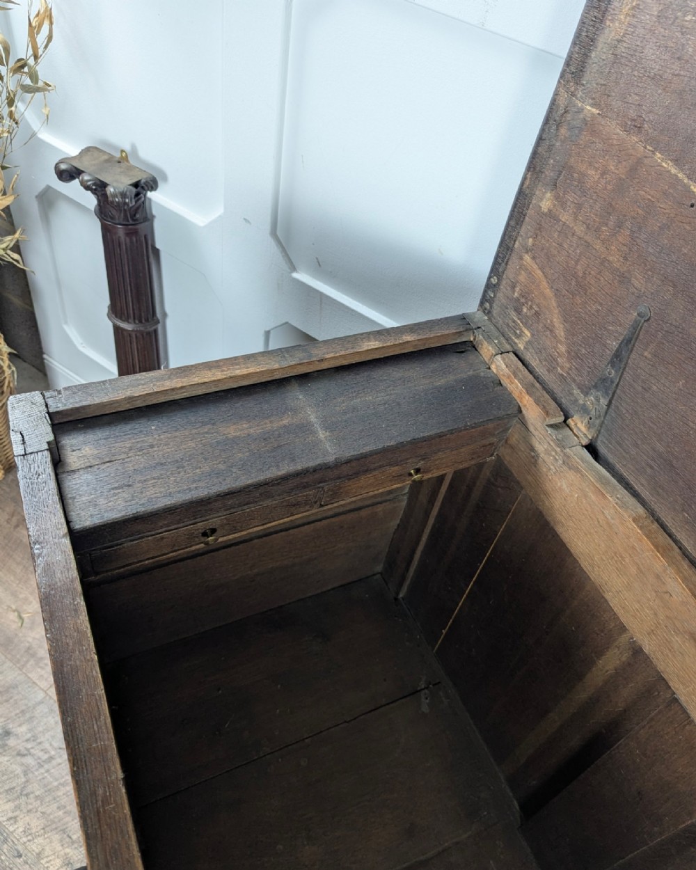 An 18th-century dark oak mule chest featuring four fielded front panels above three small drawers with brass handles. View XV