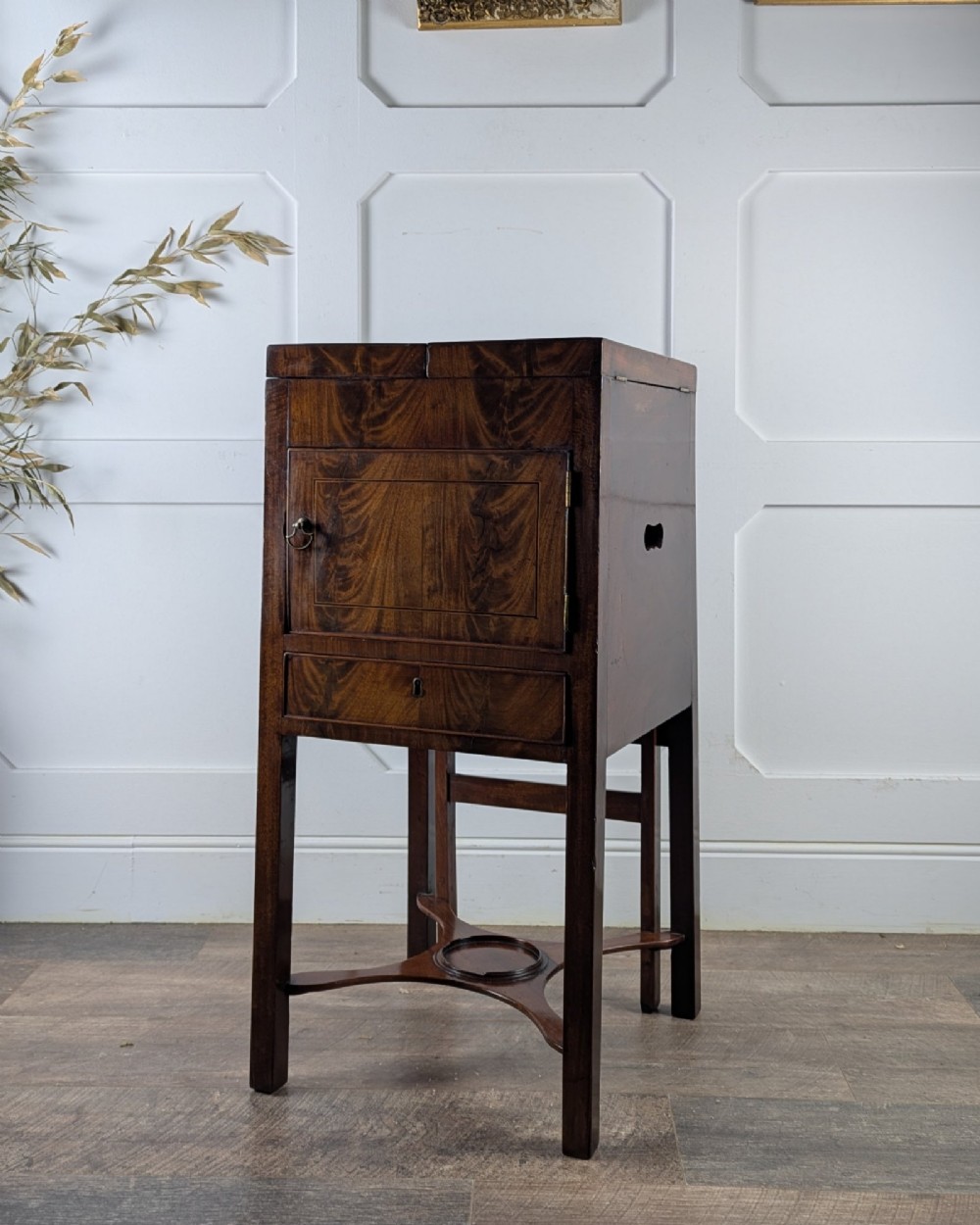 A Georgian Cuban mahogany fold-away washstand featuring an upright mirror, opened side leaves, a central cupboard, a lower drawer, and an X-frame stretcher. View III