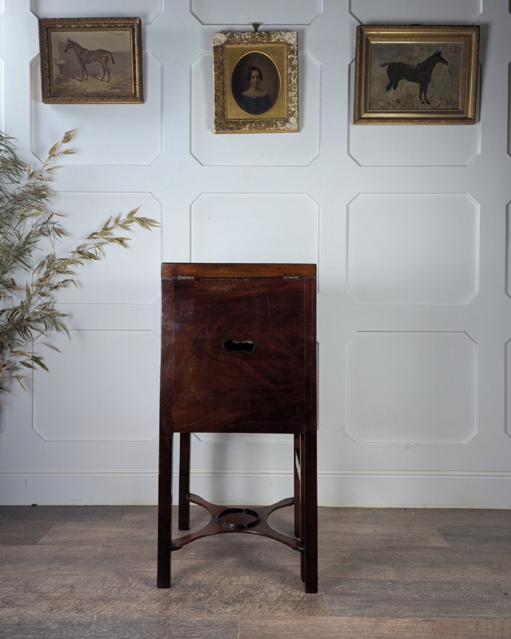 A Georgian Cuban mahogany fold-away washstand featuring an upright mirror, opened side leaves, a central cupboard, a lower drawer, and an X-frame stretcher. View V